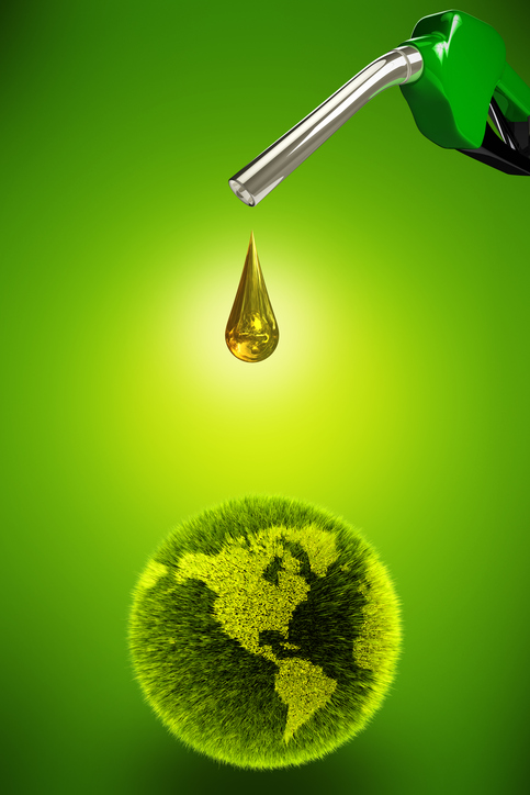 Gas pump dropping clean oil onto a green grass planet