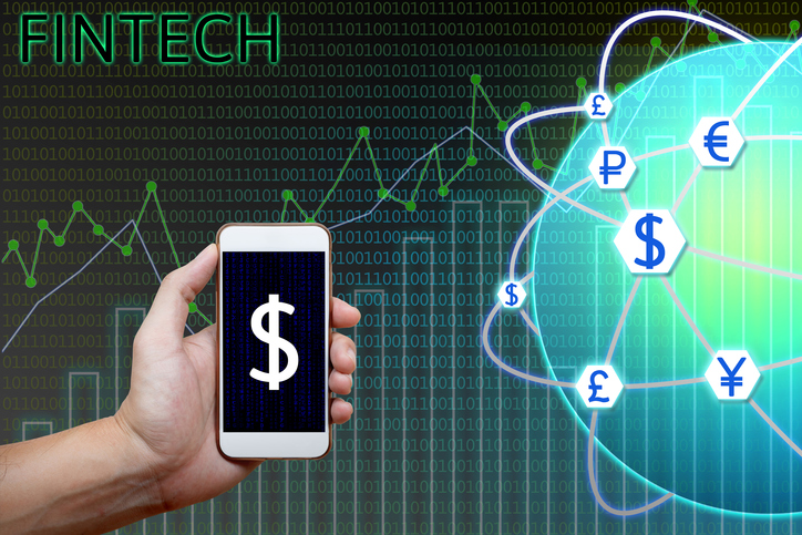 Financial technology (Fintech) concept. Man holding smartphone and charts, graph analyzing with currency global network and binary background.