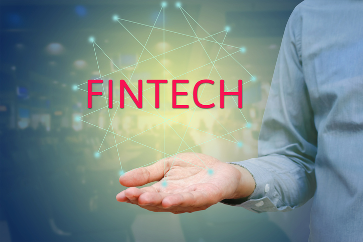 Financial and Technology (FinTech) concept. Businessman show text FINTECH on hand and networking.