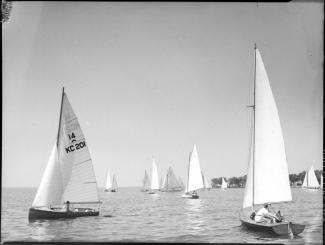 Nous voyons plusieurs voiliers participant à des régates à Pointe-Claire. Nous apercevons le voilier KC 201 de R. H. Stevenson.