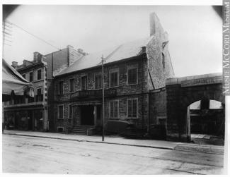 Photographie en noir et blanc d’une maison en pierre.