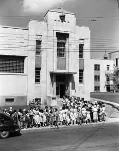 Groupe de jeunes femmes devant le bâtiment abritant le bain Rosemont.