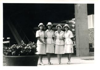 Quatre jeunes femmes, en costume d'hôtesse, à Terre des Hommes.
