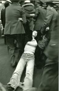 Claire Morissette est traînée au sol par deux policiers.