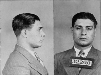 Photographie en noir et blanc en plan rapproché d’un homme vêtu d’un complet-cravate, de face et de côté.