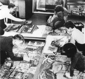Photo en noir et blanc de quatre enfants et une femme qui peignent sur des toiles sur le plancher d'un appartement