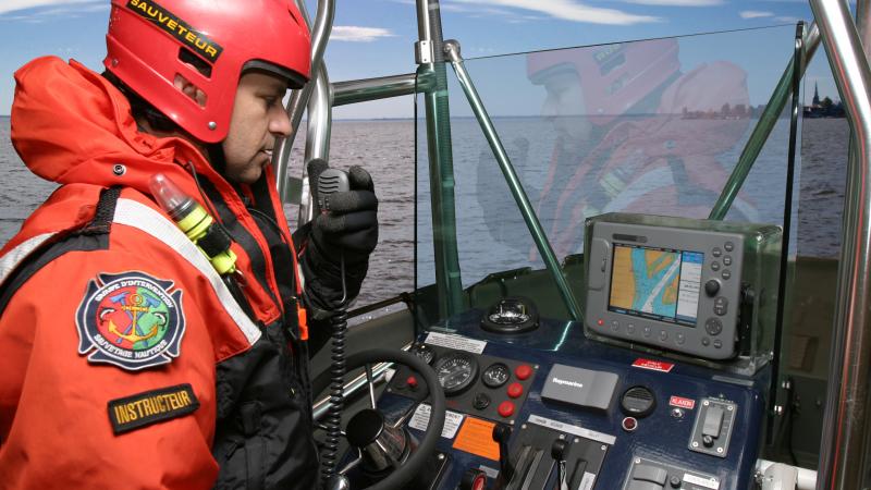 A fireman-rescue worker in a boat during a marine rescue simulation