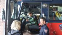 Residents chat with a firefighter on a visit to the fire station