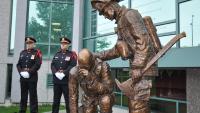 La garde d’honneur du SIM devant le monument en hommage aux pompiers décédés du Québec