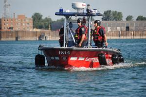 Firefighters-rescue workers in a boat during a marine rescue simulation 