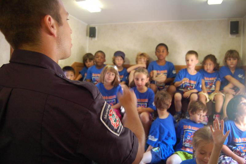 A fire safety educator shares tips with children. 
