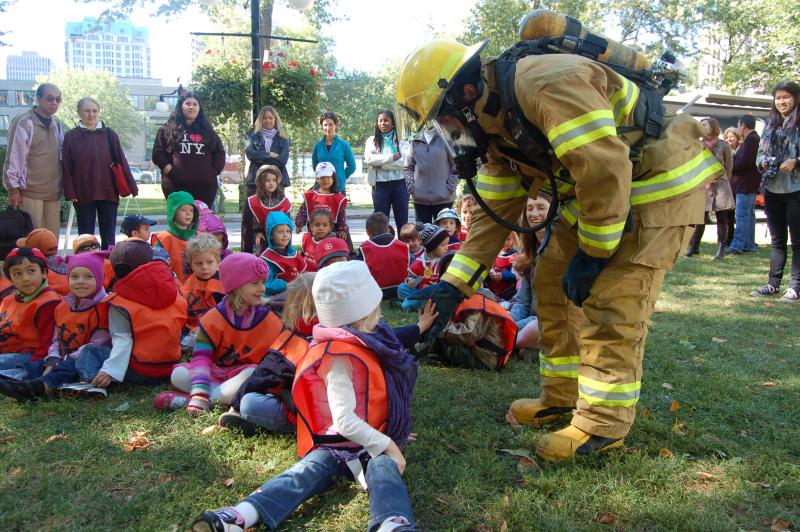 A fire safety educator speaks to children during an awareness-raising activity at McGill University.