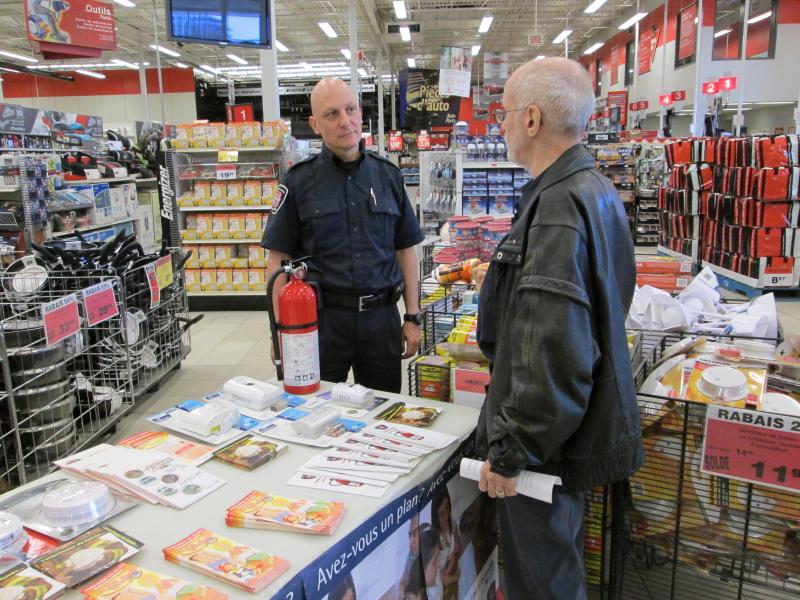 A prevention officer speaks during an awareness-raising activity at Canadian Tire