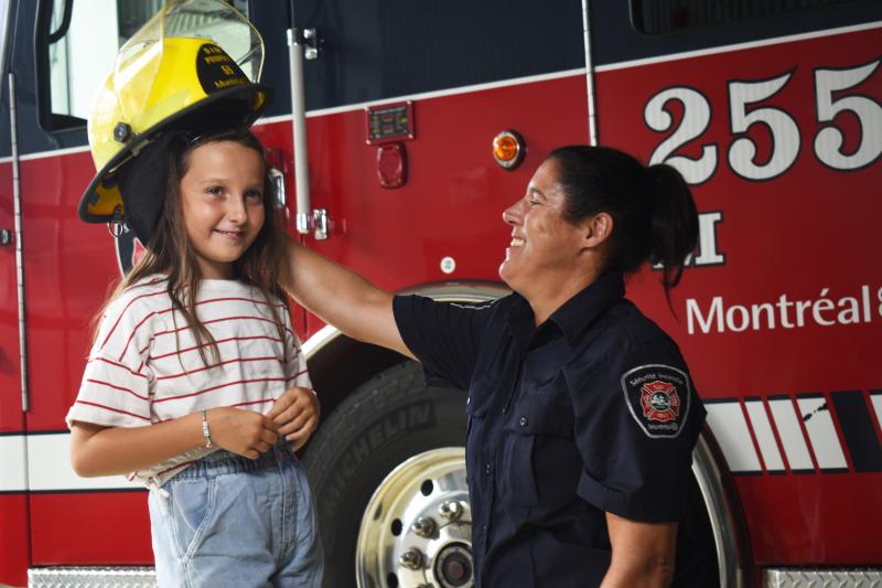 Residents chat with a firefighter on a visit to the fire station