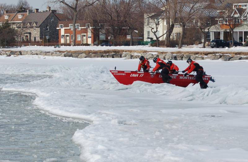 Firefighters-rescue workers in a boat during an ice rescue simulation 