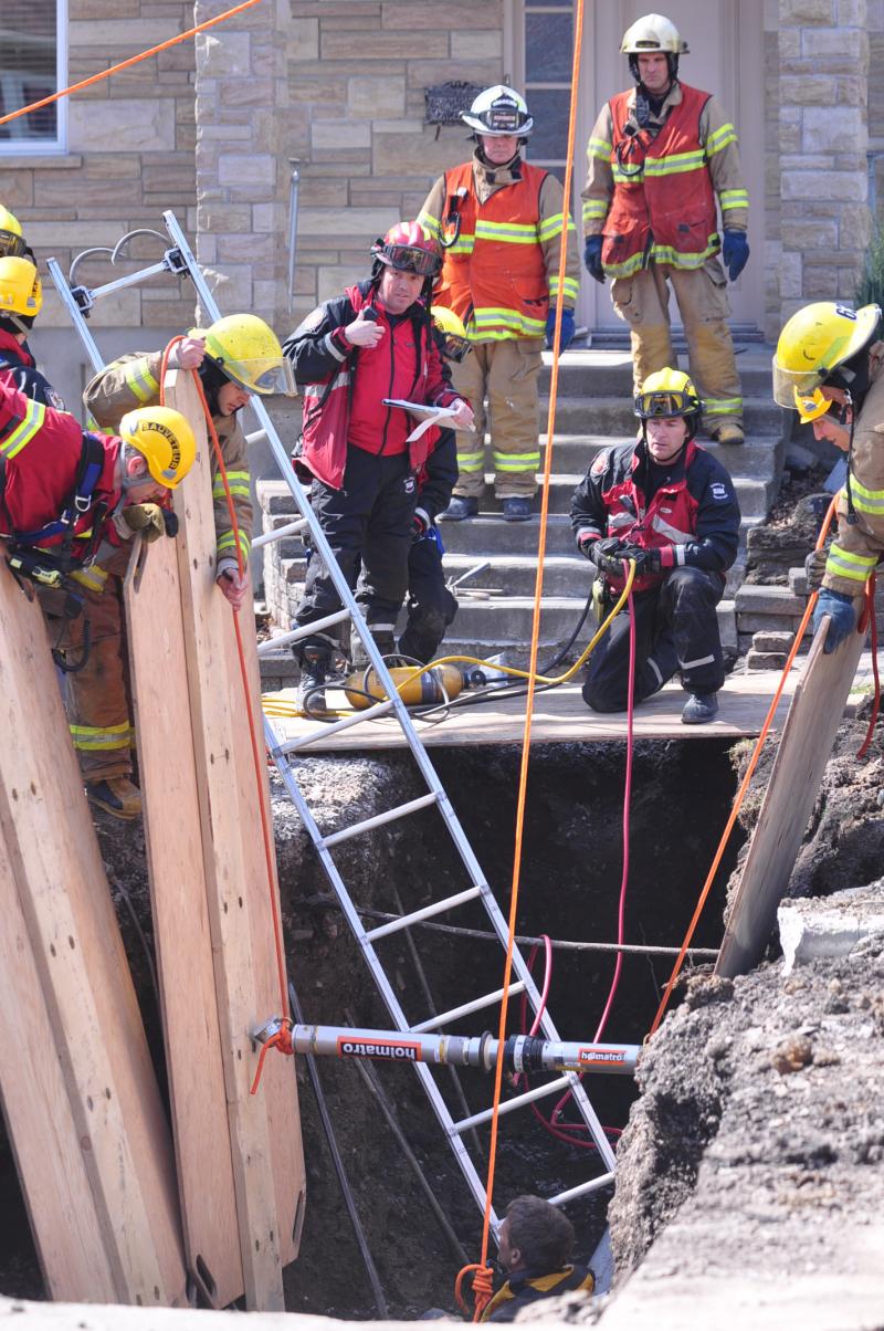 A specialized team performs a trench rescue operation after a landslide.
